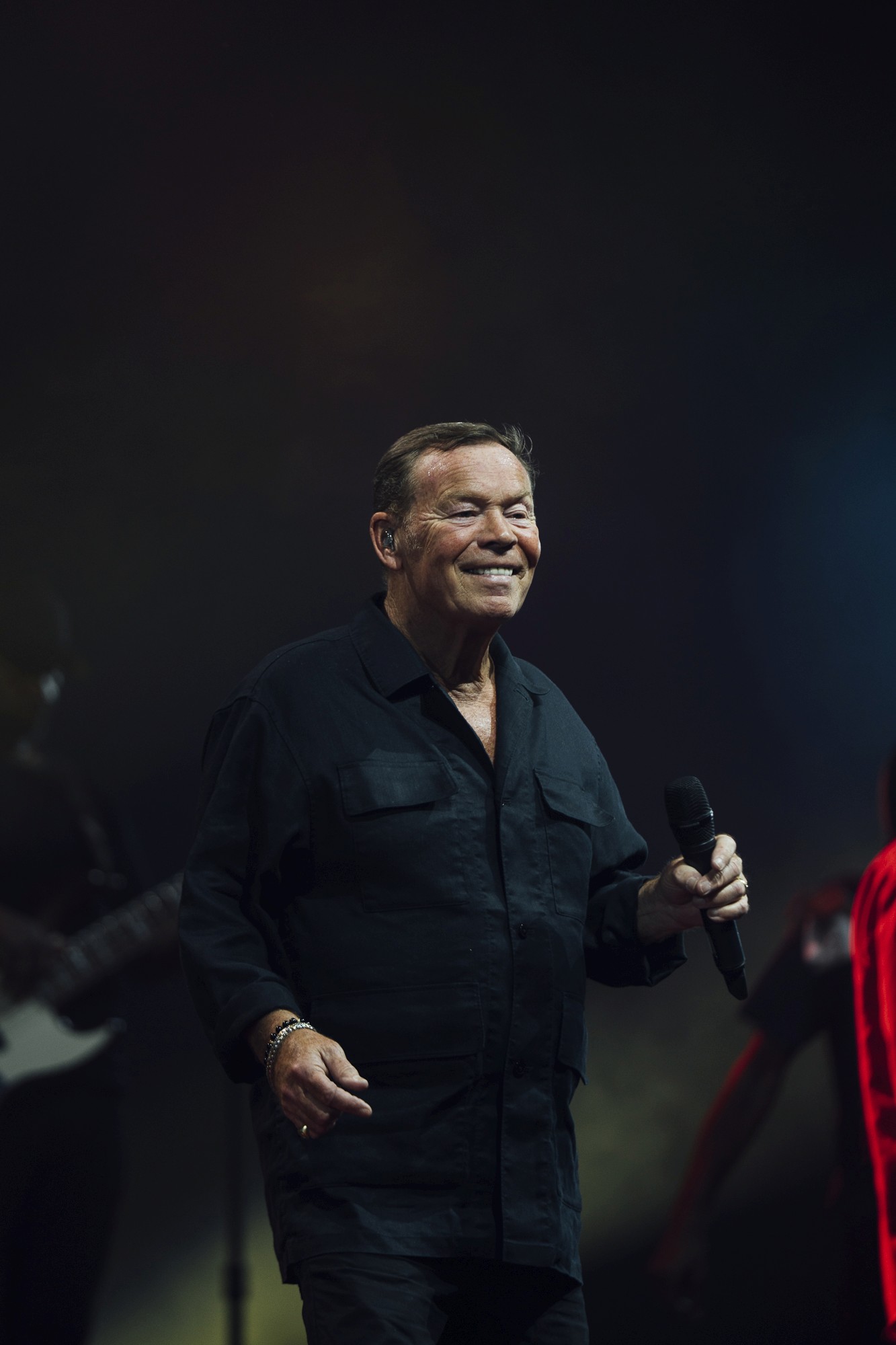 Performer under spotlight on dark stage